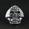 Stainless steel polished flaming skull ring on a black leather background.