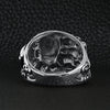 Stainless steel polished multiple skulls ring back view on a black leather background.