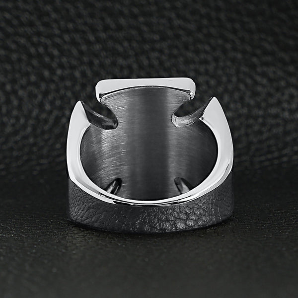 Stainless steel polished skull Maltese Cross ring back view on a black leather background.