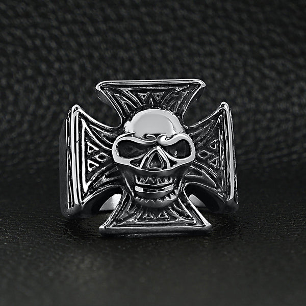 Stainless steel polished skull Maltese Cross ring on a black leather background.