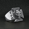 Stainless steel polished skull Maltese Cross ring angled on a black leather background.