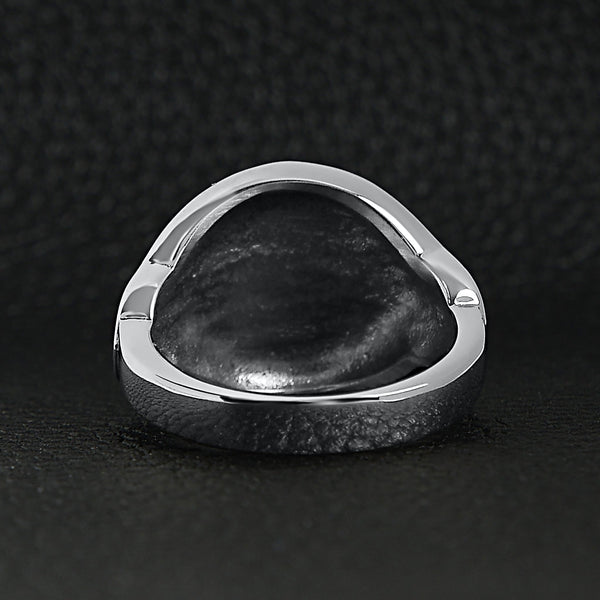 Stainless steel medieval sword and shield ring back view on a black leather background.