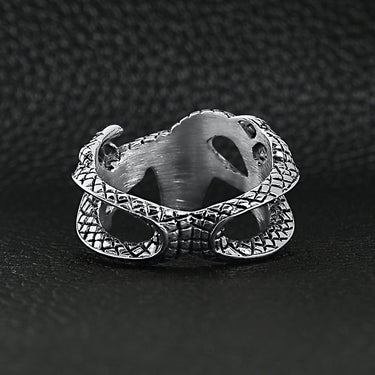 Stainless steel eastern dragon ring back view on a black leather background