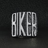 Stainless steel polished "BIKER" men's ring on a black leather background.