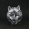 Stainless steel polished snarling wolf ring on a black leather background.