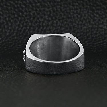 Stainless steel polished black Fleur De Lis ring back view on a black leather background.
