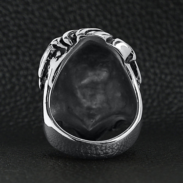 Stainless steel roaring lion head ring back view on a black leather background.
