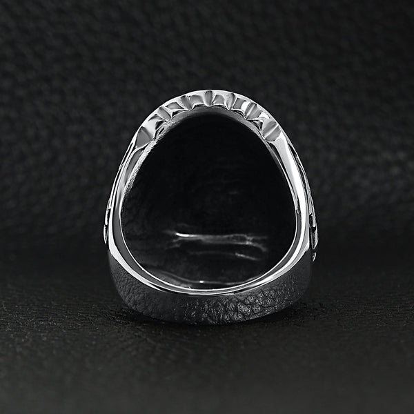 Stainless steel Native American Chief ring back view on a black leather background.
