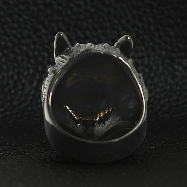 Stainless steel black wolf with 18K gold PVD Coated teeth ring back view on a black leather background.