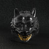 Stainless steel black wolf with 18K gold PVD Coated teeth ring on a black leather background.