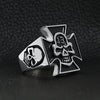 Stainless steel "13" skull Maltese Cross ring angled on a black leather background.