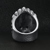 Stainless steel black Cubic Zirconia eyed Native American chief skull ring back view on a black leather background.