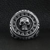 Stainless steel large filigree skull signet ring on a black leather background.