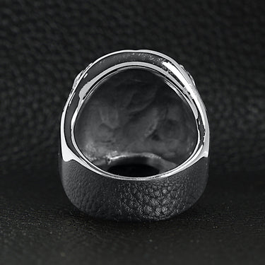 Stainless steel black Cubic Zirconia eyed skull with clear Cubic Zirconia UK flag ring back view on a black leather background.