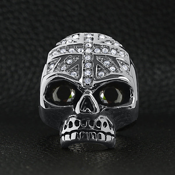 Stainless steel black Cubic Zirconia eyed skull with clear Cubic Zirconia UK flag ring on a black leather background.