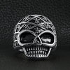 Stainless steel skull with Fleur De Lis pattern ring on a black leather background.