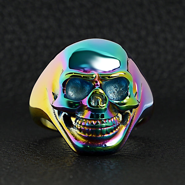 Stainless steel rainbow skull ring on a black leather background.