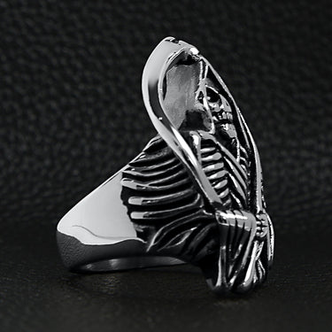 Stainless steel Grim Reaper with scythe ring angled on a back leather background.