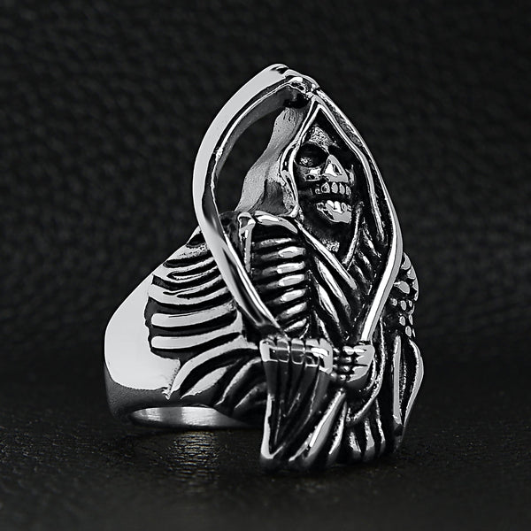 Stainless steel Grim Reaper with scythe ring on a back leather background.