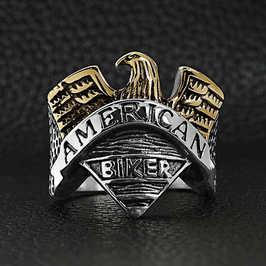Stainless steel "AMERICAN BIKER" with 18K gold PVD Coated eagle ring on a black leather background.