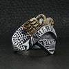 Stainless steel "AMERICAN BIKER" with 18K gold PVD Coated eagle ring angled on a black leather background.