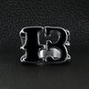 Stainless steel black gothic "13" dragon claw signet ring on a black leather background.