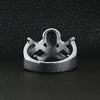 Stainless steel pirate Jolly Roger skull with crossed swords ring back view on a black leather background.