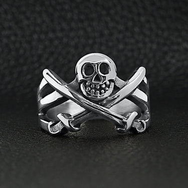 Stainless steel pirate Jolly Roger skull with crossed swords ring on a black leather background.