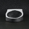 Stainless steel heavy duty "HD" signet ring back view on a black leather background.