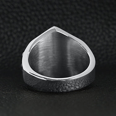 Stainless steel "1%er" with skull accents signet ring back view on a black leather background.