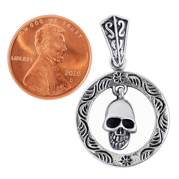 Sterling silver circle skull pendant with a penny for scale.