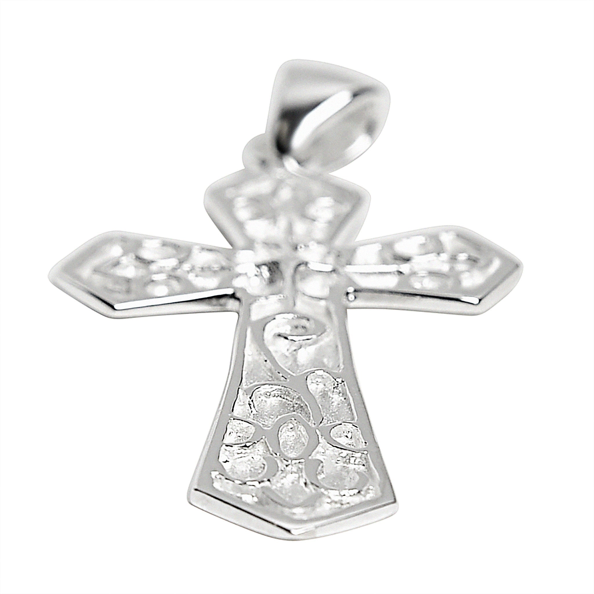 Sterling silver filigree cross pendant at an angle.