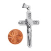 Sterling silver crucifix pendant with a penny for scale.