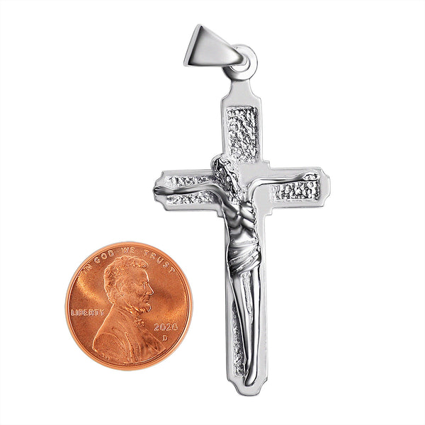 Sterling silver crucifix pendant with a penny for scale.