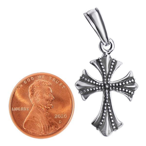 Sterling silver cross pendant with a penny for scale.