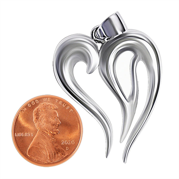 Sterling silver heart pendant with a penny for scale.
