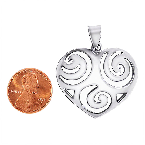 Sterling silver swirl heart pendant with a penny for scale.