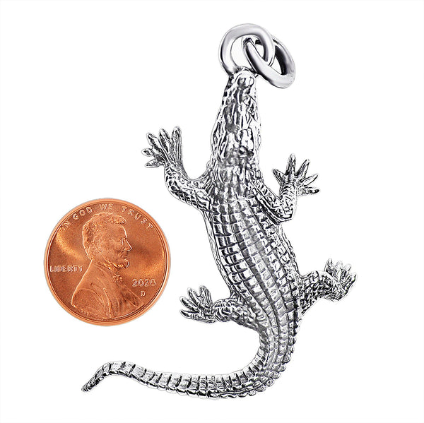 Sterling silver alligator pendant with a penny for scale.