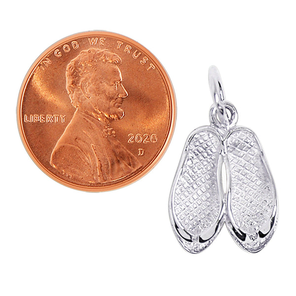 Sterling silver flip flops or sandals pendant with a penny for scale.