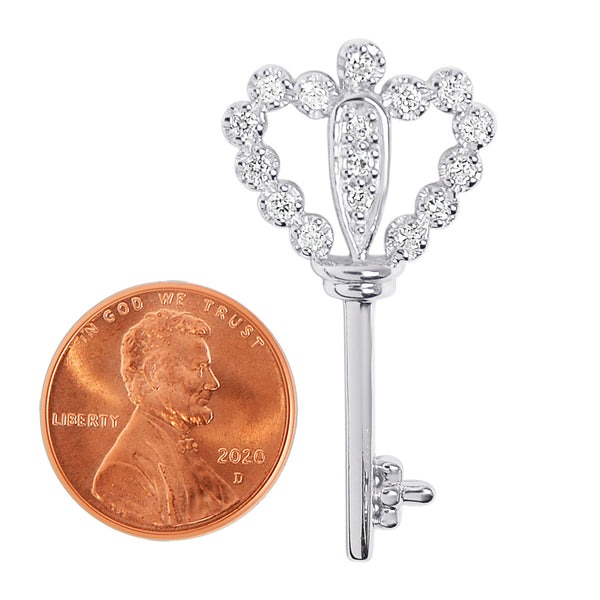 Sterling silver Cubic Zirconia heart key pendant with a penny for scale.
