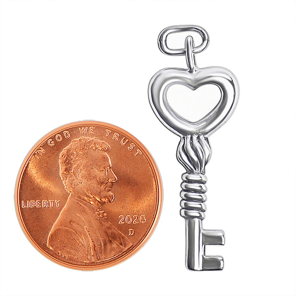 Sterling silver heart key pendant with a penny for scale.