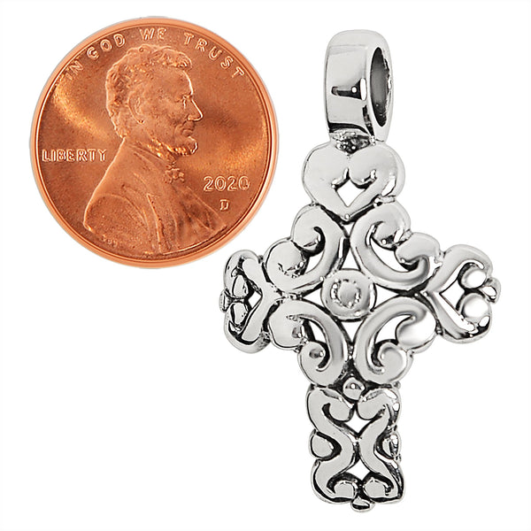 Sterling silver filigree Cross pendant with a penny for scale.