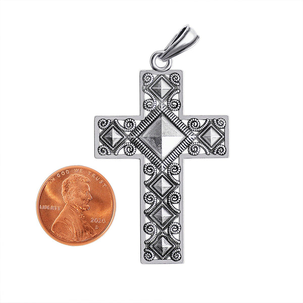 Sterling silver diamond shape filigree Cross pendant with a penny for scale.