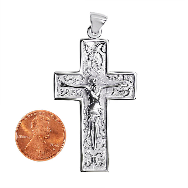 Sterling silver filigree Crucifix Cross pendant with a penny for scale.