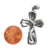 Sterling silver Crucifix Cross pendant with a penny for scale.
