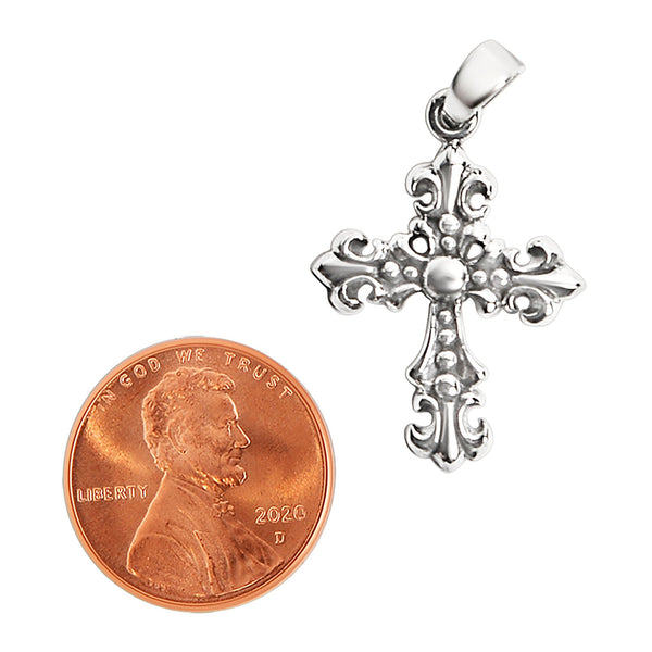 Sterling silver filigree Cross pendant with a penny for scale.