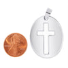Sterling silver oval Cross cutout pendant with a penny for scale.