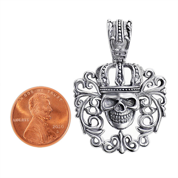 Sterling silver filigree king skull pendant with a penny for scale.