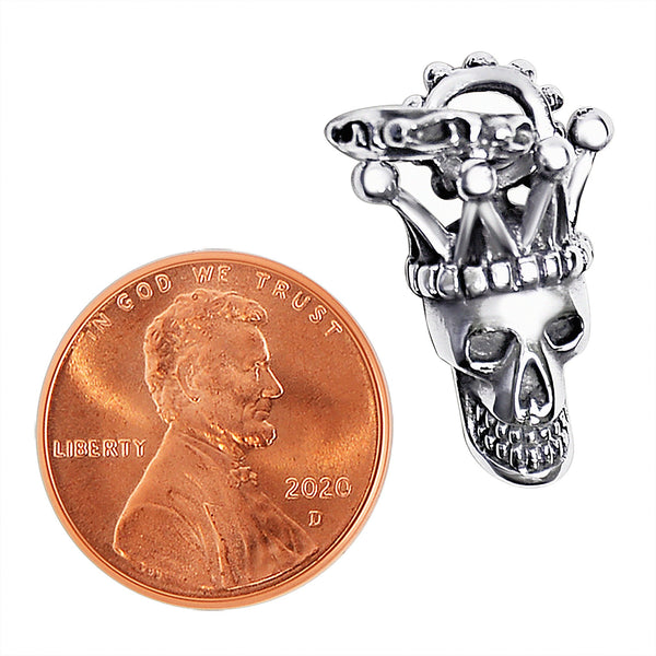 Sterling silver jester skull pendant with a penny for scale.