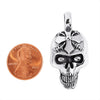 Sterling silver skull pendant with a penny for scale.